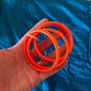 Orange and rhinestone bangle bracelets. Three. Some missing rhinestones.
